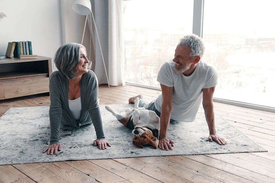 Couple Stretching with Dog